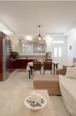 a living room with a couch and a table at Pearl of Stegna - Beach House in Archangelos