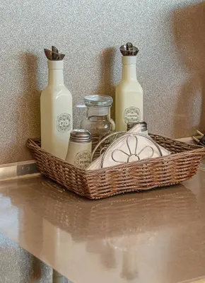 a basket with four bottles on top of a table at Pearl of Stegna - Beach House in Archangelos