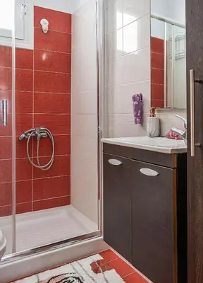 a bathroom with a shower and a sink at Pearl of Stegna - Beach House in Archangelos
