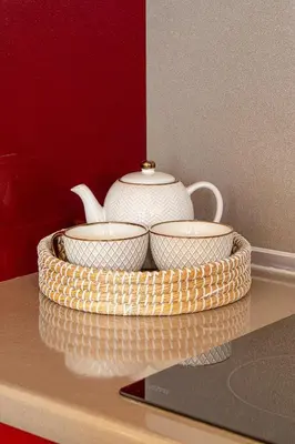 a tray with two cups and a tea pot on a counter at Pearl of Stegna - Beach House in Archangelos