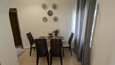 a dining room with a table and chairs and plates on the wall at GIANNIS HOUSE in Rhodes Town