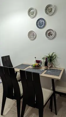a dining room table with chairs and plates on the wall at GIANNIS HOUSE in Rhodes Town