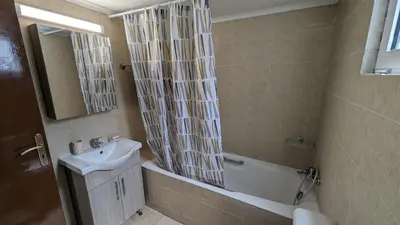 a bathroom with a sink and a tub and a shower at GIANNIS HOUSE in Rhodes Town