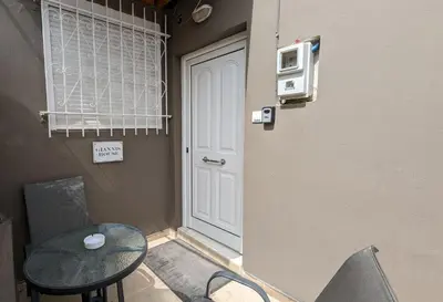 a room with a table and a door and a table and chairs at GIANNIS HOUSE in Rhodes Town