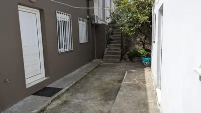 an alley with a white door and stairs next to a building at GIANNIS HOUSE in Rhodes Town