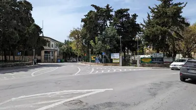 an empty street with cars parked on the road at GIANNIS HOUSE in Rhodes Town