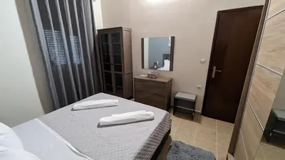 a small room with a bed and a mirror at GIANNIS HOUSE in Rhodes Town