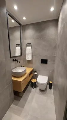 a bathroom with a sink and a toilet and a mirror at Amerikis Central Apart in Rhodes Town