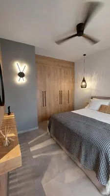a bedroom with a bed and a ceiling fan at Amerikis Central Apart in Rhodes Town