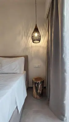 a bedroom with a bed and a table and a lamp at Amerikis Central Apart in Rhodes Town