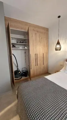 a bedroom with a bed and a cupboard and a bed sidx sidx at Amerikis Central Apart in Rhodes Town
