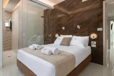 a bedroom with a large bed with towels on it at Rhodes Skyline Suite with In Door Jacuzzi Sea View in Ixia