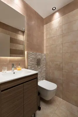 a bathroom with a toilet and a sink and a mirror at Rhodes Skyline Suite with In Door Jacuzzi Sea View in Ixia