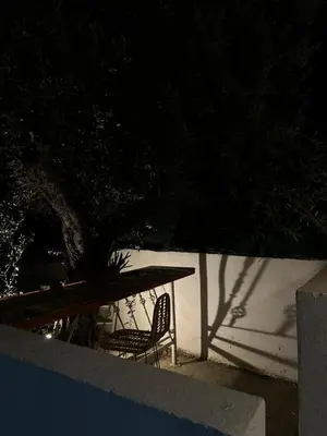 a table and a chair with a table and a tree at Flowers Lullaby Loft in Afantou
