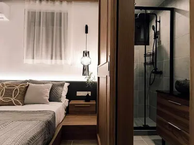 a bedroom with a bed and a shower at Arsithea Villa in Monólithos
