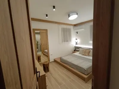 a bedroom with a bed and a mirror at Arsithea Villa in Monólithos