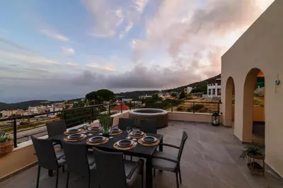 a table and chairs on a balcony with a view at Arsithea Villa in Monólithos