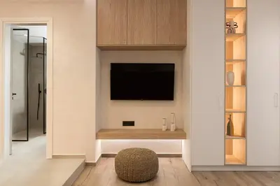 a living room with a tv on a wall at HELENA’S RETREAT in Rhodes Town