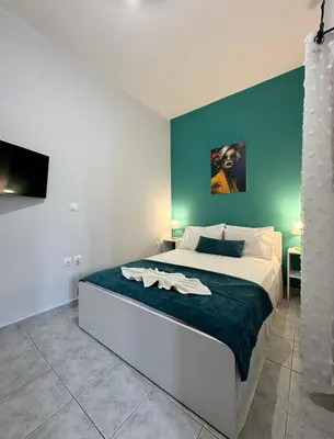 a bedroom with a large bed with a green wall at Aesthetic Cozy Haven in Kremasti