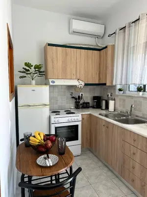 a kitchen with a table with a bowl of fruit on it at Aesthetic Cozy Haven in Kremasti
