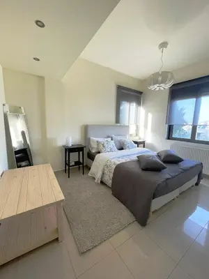 a large bedroom with a bed and a table at Calm Haven 2024 in Ialyssos