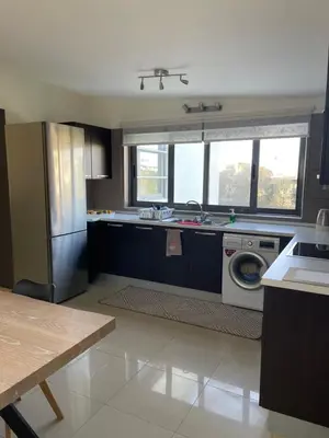 a kitchen with a sink and a washing machine at Calm Haven 2024 in Ialyssos