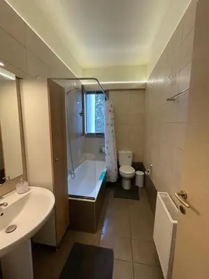a bathroom with a tub and a toilet and a sink at Calm Haven 2024 in Ialyssos