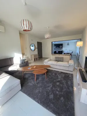 a living room with a couch and a coffee table at Calm Haven 2024 in Ialyssos