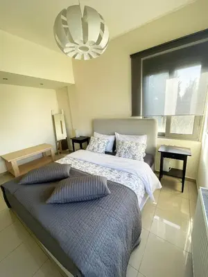 a bedroom with two beds and a chandelier at Calm Haven 2024 in Ialyssos