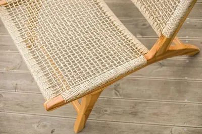 a wicker chair sitting on top of a table at Villa Kaya in Haraki