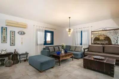 a living room with a couch and a table at Villa Kaya in Haraki