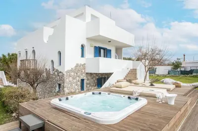 a villa with a hot tub on a wooden deck at Villa Kaya in Haraki