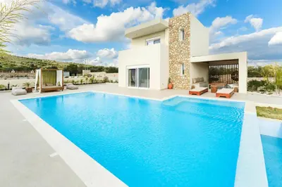 a swimming pool in front of a villa at Aiolia Villa in Lachania