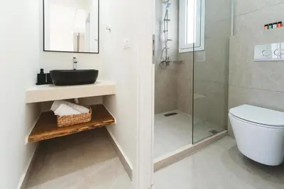 a bathroom with a sink and a shower at Aiolia Villa in Lachania