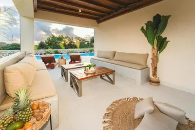 a living room with a couch and a table at Aiolia Villa in Lachania
