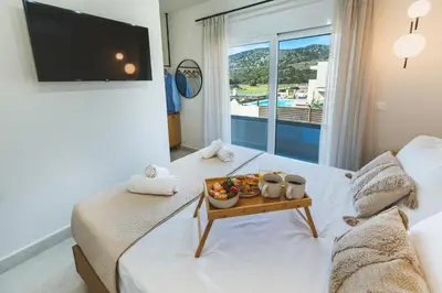 a hotel room with a tray of fruit on a bed at Cleopatras Villa in Lachania