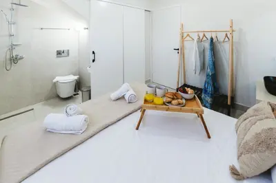 a bathroom with a bed and a table with food on it at Cleopatras Villa in Lachania