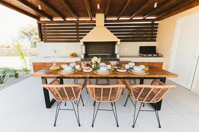 a dining room table and chairs in a kitchen at Cleopatras Villa in Lachania
