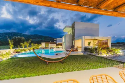 a villa with a hammock and a swimming pool at Cleopatras Villa in Lachania