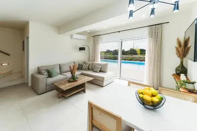 a living room with a couch and a table at Cleopatras Villa in Lachania