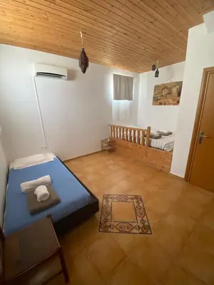 a room with a blue bed and a bedroom at White Houses Villas in Gennadi