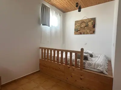 a bedroom with a bed and a window at White Houses Villas in Gennadi