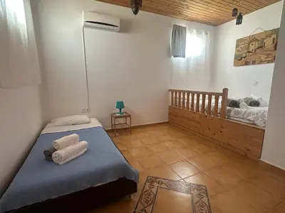 a bedroom with a bed with towels on it at White Houses Villas in Gennadi