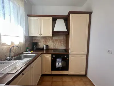 a kitchen with a sink and a stove top oven at White Houses Villas in Gennadi