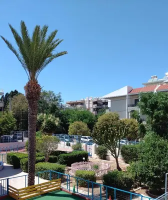 a palm tree in a park with a golf court at Mary's House in Rhodes Town
