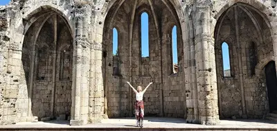 a person standing in front of an old building at Mary's House in Rhodes Town