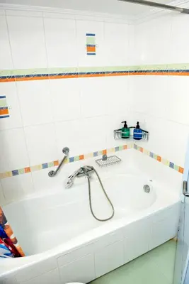 a white bath tub with a faucet in a bathroom at Mary's House in Rhodes Town