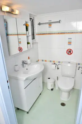 a white bathroom with a sink and a toilet at Mary's House in Rhodes Town