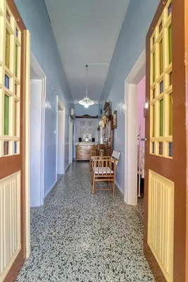 a hallway with a table and chairs in a room at Waterfront House Pedi in Symi