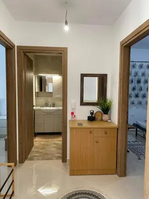 a room with a kitchen with a sink and a mirror at Rhodes Volkshaus in Afantou